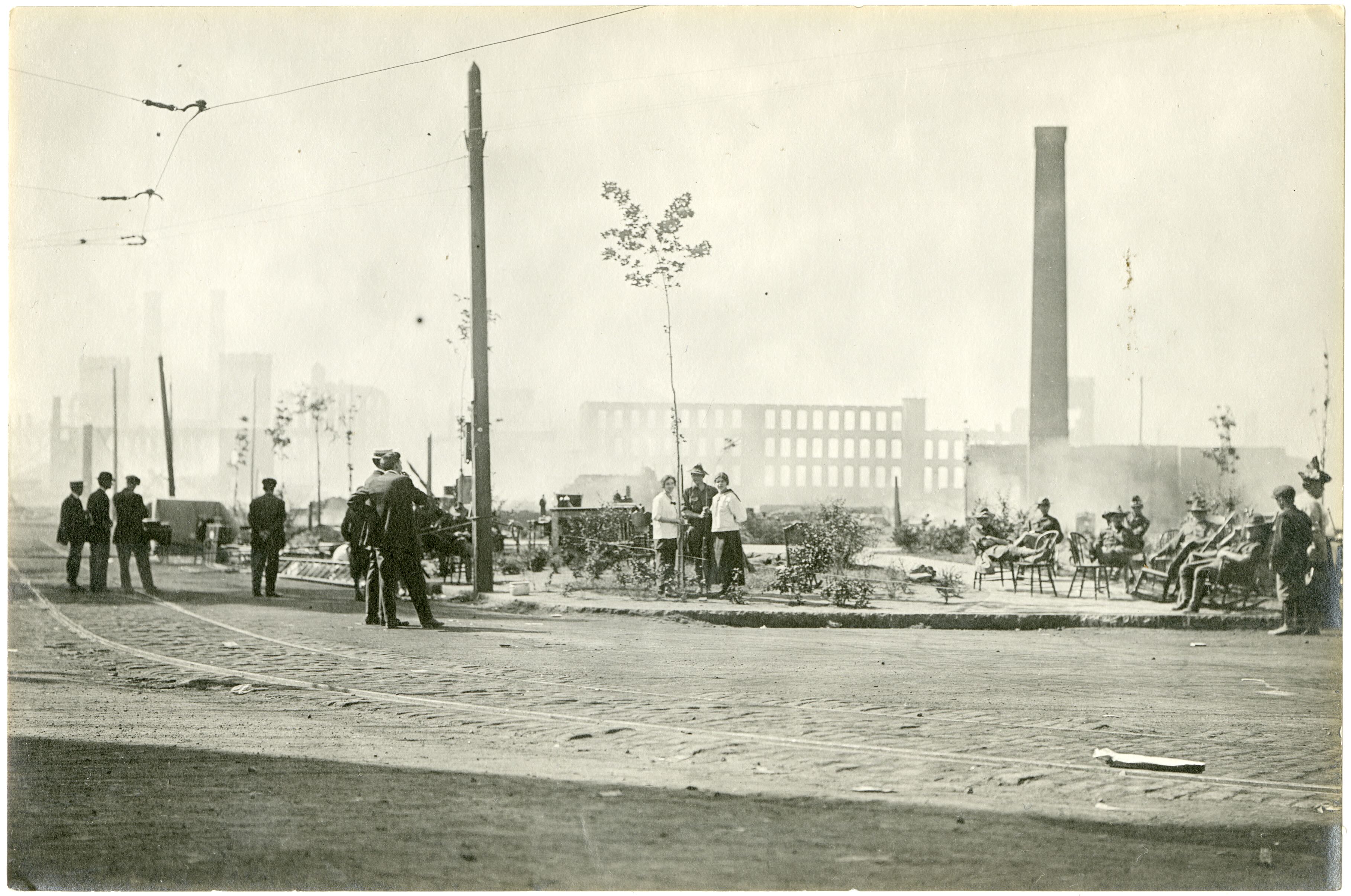 Militia members and civilians in front of the ruins of Pequot Mills