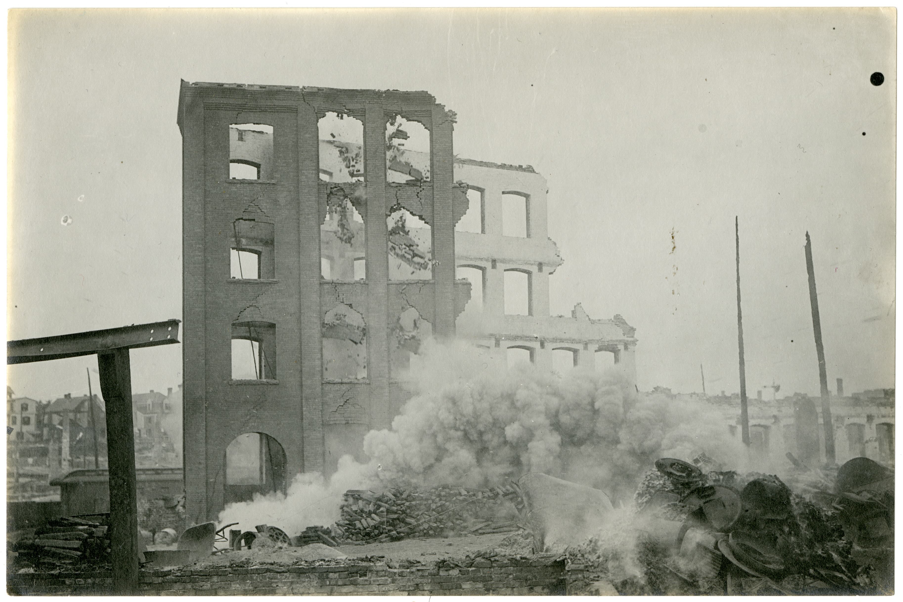 Debris falls from a burned out building