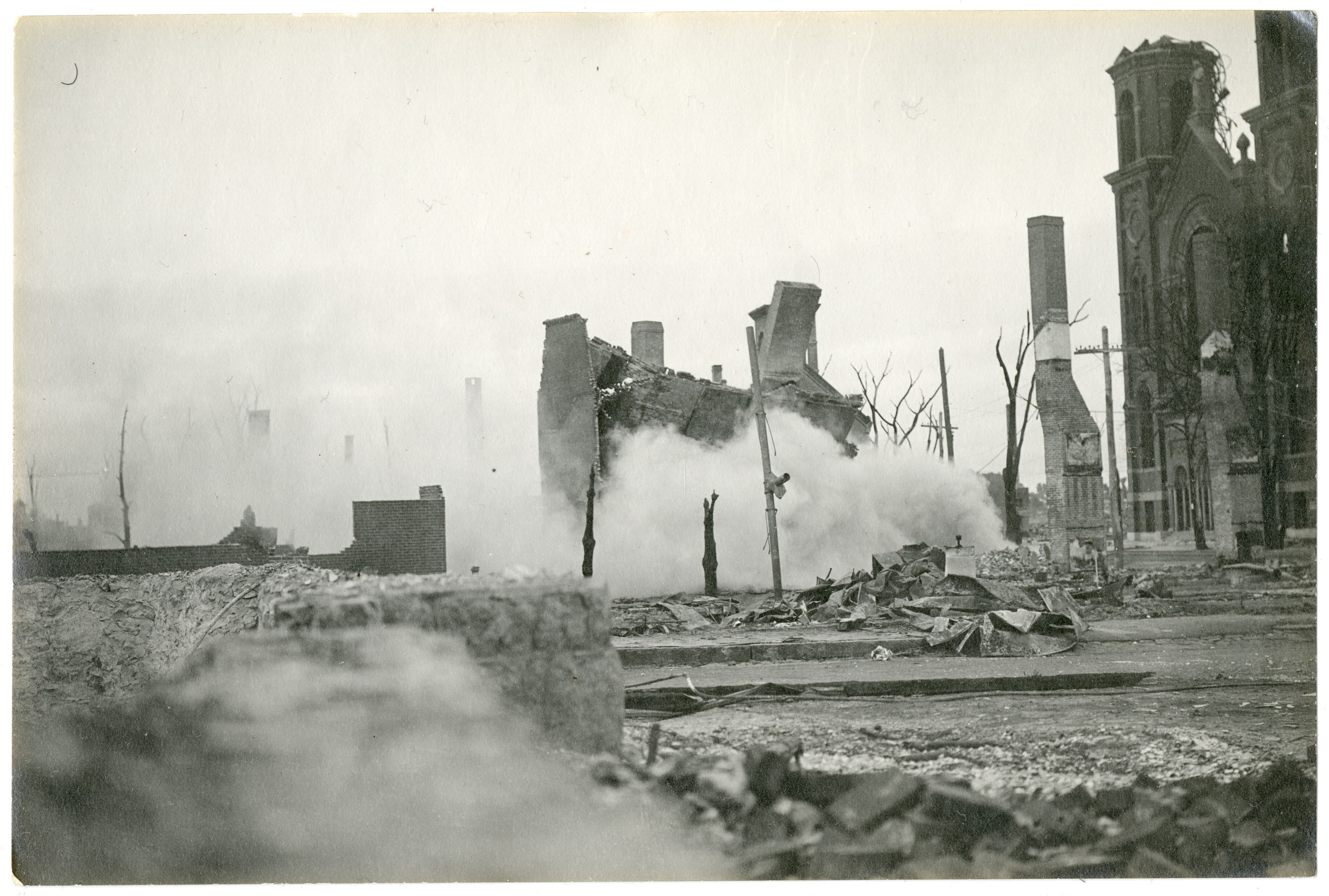 A burned building falls in front of Saint Joseph's Church