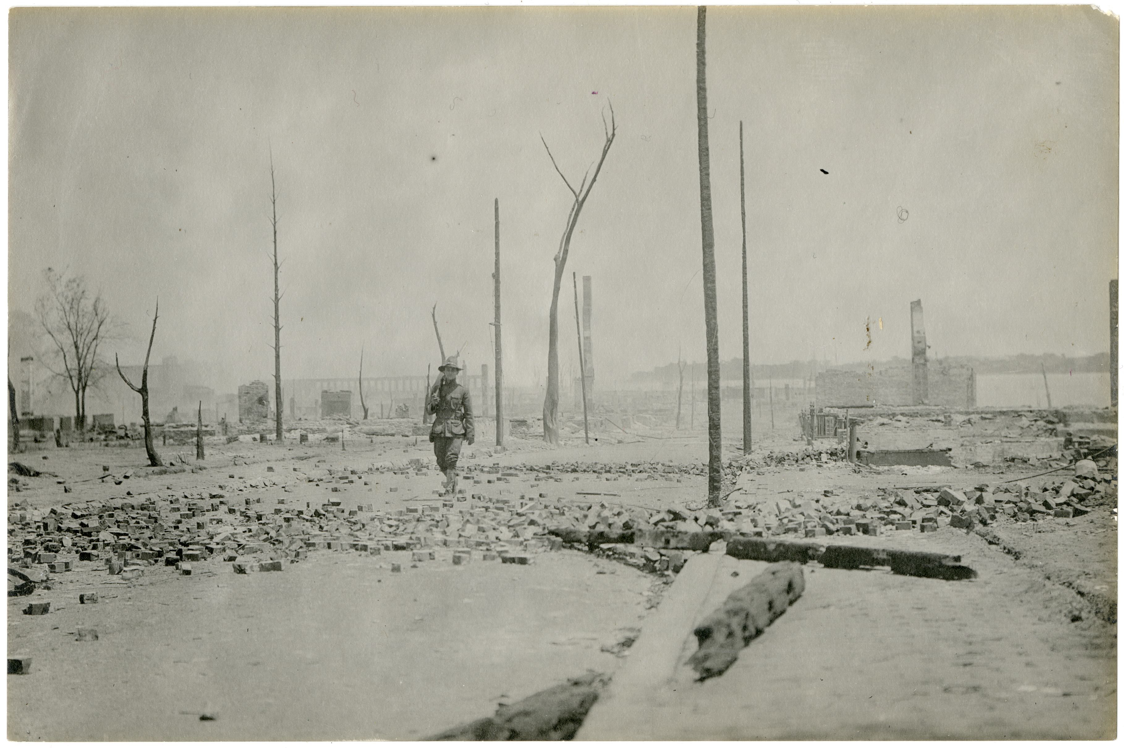 Militia member patrolling ruins