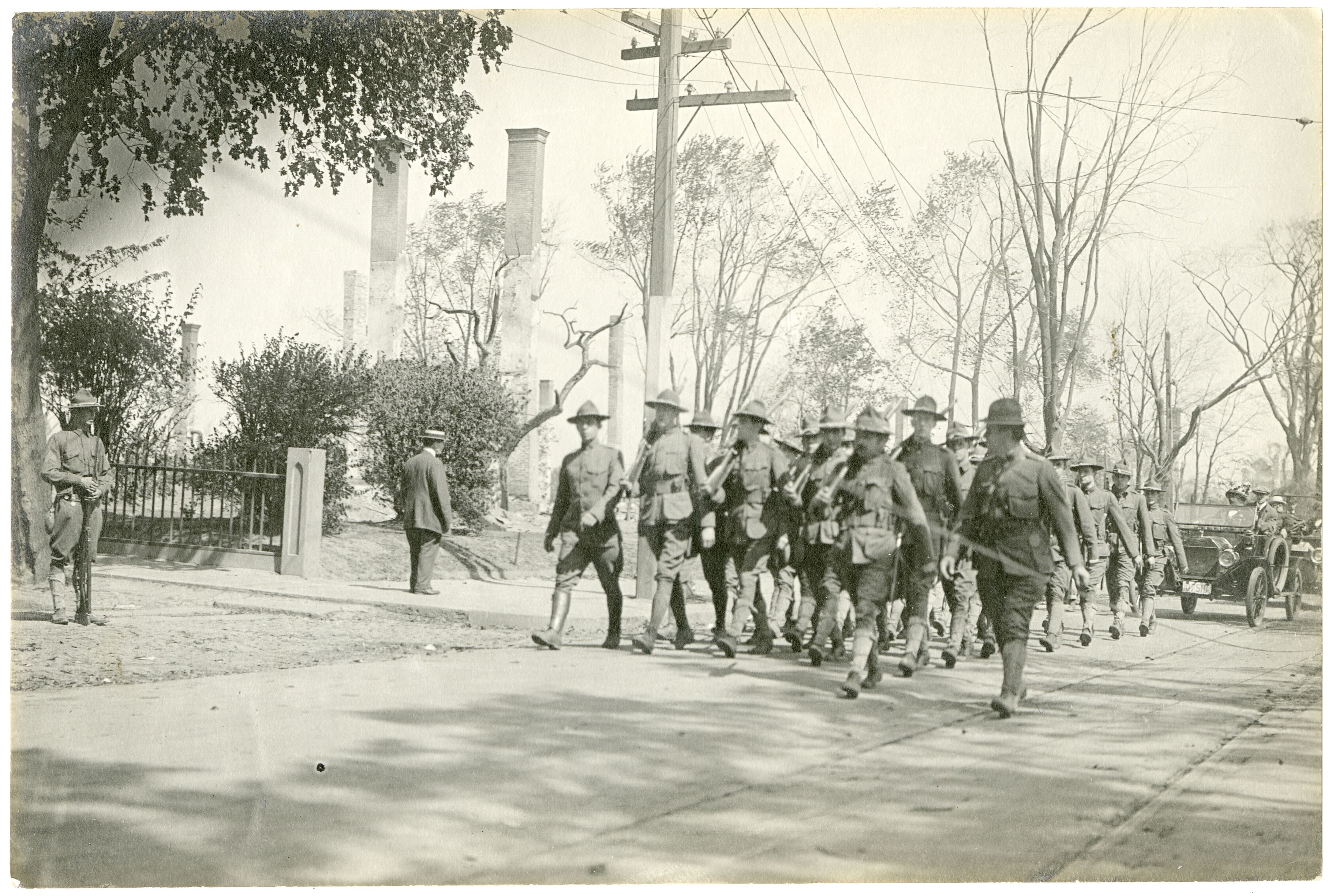 Militia members marching down the street